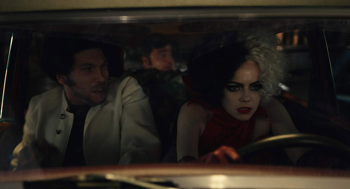 (L-R): Joel Fry as Jasper, Paul Walter Hauser as Horace and Emma Stone as Cruella in Disney’s live-action CRUELLA. Photo courtesy of Disney. © 2021 Disney Enterprises Inc. All Rights Reserved.