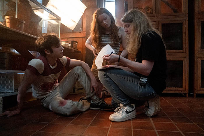 Fear Street Part 2: 1978 - (L-R) BTS of TED SUTHERLAND as NICK and SADIE SINK as ZIGGY and Director Leigh Janiak. Cr: Jessica Miglio/Netflix © 2021